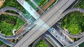 An aerial view of a complex highway interchange with futuristic digital overlays, visualizing smart transportation, autonomous vehicles, data connectivity, and intelligent traffic management systems. - Powered by Shutterstock - Get 15% off with code: PIKWIZARD15