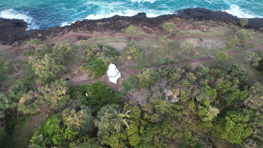 Scenic view of Fingal Head Lighthouse with the causeway rock formations below in Fingal Head, New South Wales, Australia