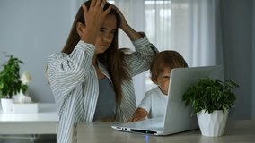 Woman getting ready for work from home with child sitting next to her. Parent balancing work and childcare. Studying or working from home. Online job business, remote work. - Powered by Shutterstock - Get 15% off with code: PIKWIZARD15