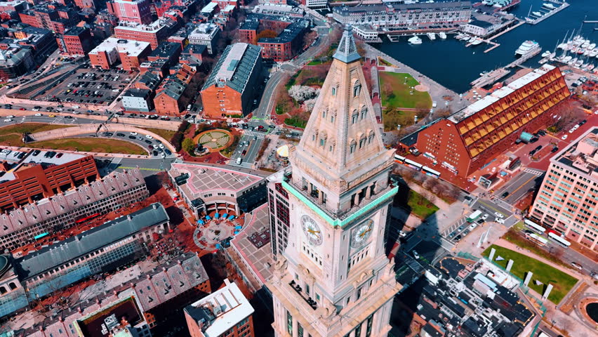 Flight at the clock tower of Custom House Tower, MA, USA. Bright city panorama from top view on sunny day.