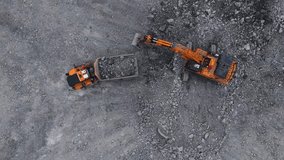Aerial top view Excavator loading gold and copper ore into dump truck in open pit mine, mining industry. - Powered by Shutterstock - Get 15% off with code: PIKWIZARD15