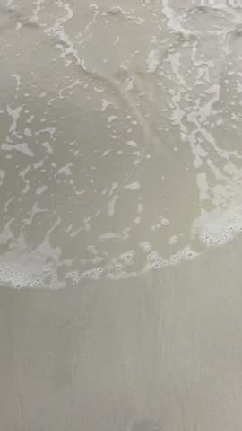 The crashing waves on the white sand
