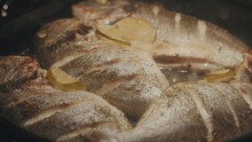 Cooked dorado with lemon slices served on a rustic table with sea stars and coarse salt - Powered by Shutterstock - Get 15% off with code: PIKWIZARD15