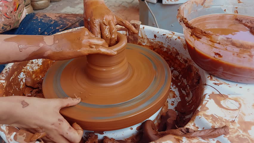 Making clay pots on a potter