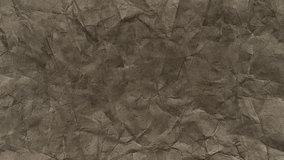 Dark faded brown crumpled paper texture with heavy folds, deep shadows, distressed vintage look, worn pulp details, recycled material surface, animated grunge texture loop - Powered by Shutterstock - Get 15% off with code: PIKWIZARD15