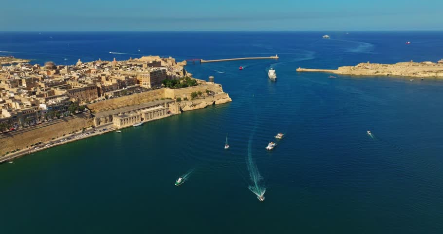 Grand harbour of Valletta. Lighthouse, sea, boats, ships. Malta