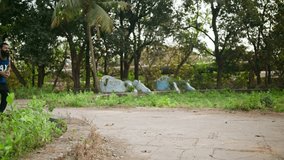 Bearded Athletic Practices Bowling at Scenic Lawn, Man Engages in Morning Health Session Playing Cricket, Male Cricketer Trains Outdoors with Ball, Sport Lover Enjoys Fitness Game, Energetic Player - Powered by Shutterstock - Get 15% off with code: PIKWIZARD15