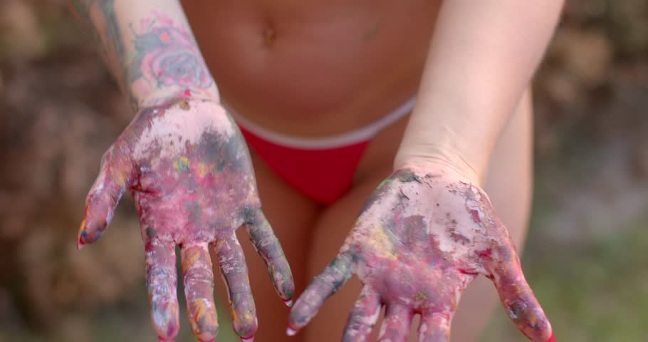 Captivating images of hands covered in vibrant paint, showcasing creativity and playful artistic expression. Perfect for art and lifestyle themes.