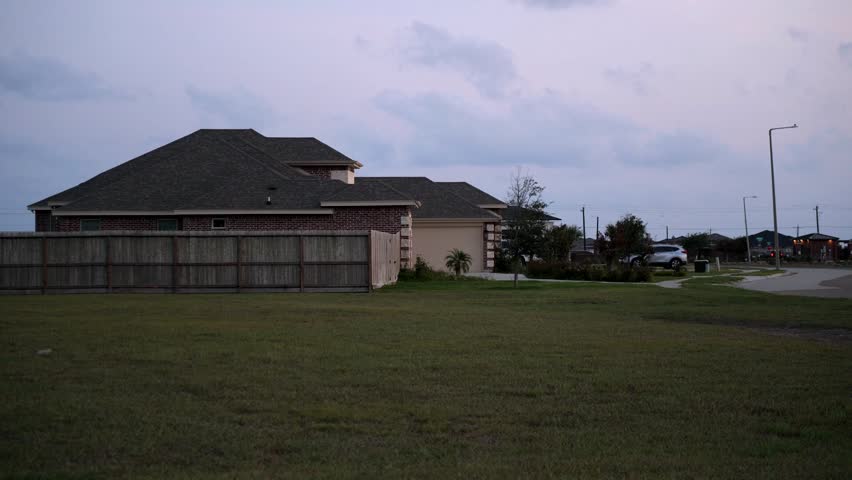 Vacant lot in front of brand new homes in new development subdivision, evoking urban change, suburbia, residential construction, gated communities, realty, home, family homes, new build homes, lawn