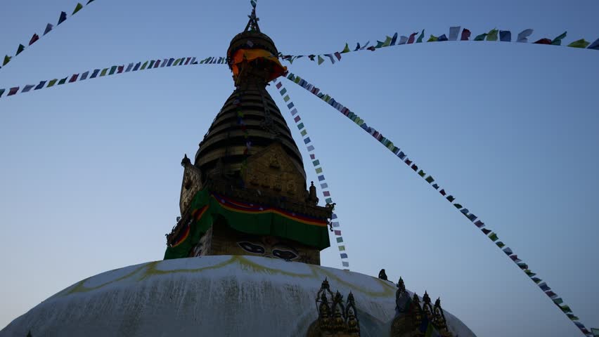 Stupa sacred place in Buddhist temple, Kathmandu , Nepal. Colorful prayer flags real time video around the stupa in Buddhist pagoda