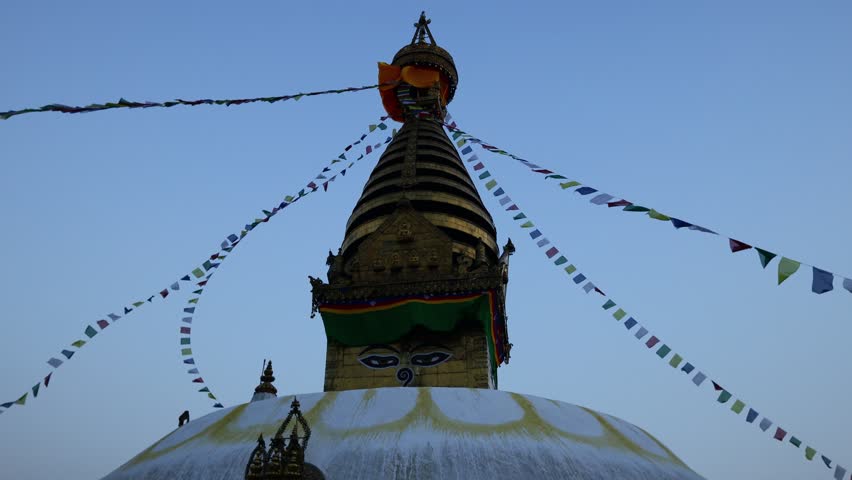 Stupa sacred place in Buddhist temple, Kathmandu , Nepal. Colorful prayer flags real time video around the stupa in Buddhist pagoda