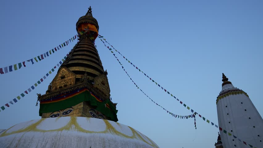Stupa sacred place in Buddhist temple, Kathmandu , Nepal. Colorful prayer flags real time video around the stupa in Buddhist pagoda