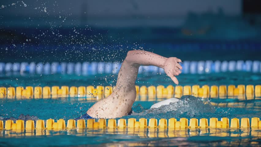 Cinemagraph. Swimmer swims freestyle swimming style in the pool.