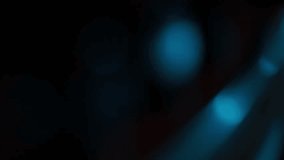 A dramatic close-up rack focus reveals the wooden bridge and strings of a cello. Moody blue and orange light creates a cinematic atmosphere against a dark background. - Powered by Shutterstock - Get 15% off with code: PIKWIZARD15