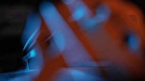 A dramatic close-up rack focus reveals the wooden bridge and strings of a cello. Moody blue and orange light creates a cinematic atmosphere against a dark background. - Powered by Shutterstock - Get 15% off with code: PIKWIZARD15