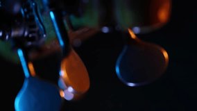 A dramatic close-up rack focus reveals the wooden bridge and strings of a cello. Moody blue and orange light creates a cinematic atmosphere against a dark background. - Powered by Shutterstock - Get 15% off with code: PIKWIZARD15