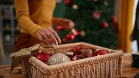 Young couple decorating christmas tree with colorful baubles and string lights in cozy living room - Powered by Shutterstock - Get 15% off with code: PIKWIZARD15