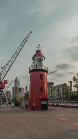 Hyperlapse of The Low Light of Hook of Holland in Rotterdam, Netherlands. Maritime Museum Harbor features historic vessels, cranes and an old lighthouse with skyscrapers in the background timelapse