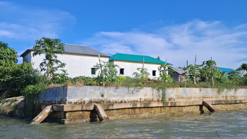 Green tree , blue sky with white fluffy clouds and water