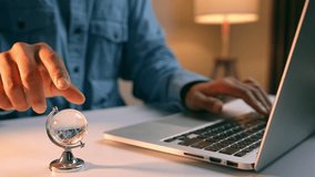 Spinning a globe while working on a laptop symbolizes global connectivity, digital exploration, remote collaboration, cross-border learning, and innovation in a tech-driven world.
 - Powered by Shutterstock - Get 15% off with code: PIKWIZARD15