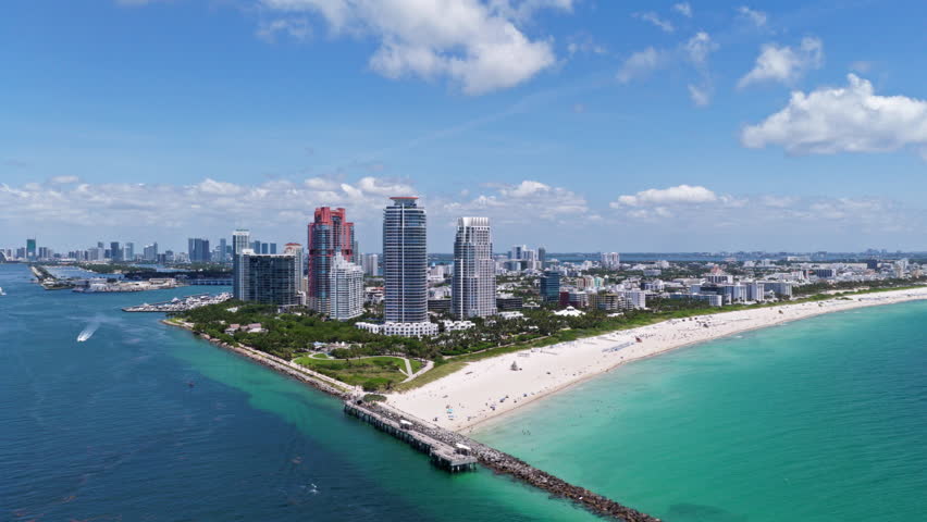 Miami skyscrapers above the coastline. Miamis coastal landscape from above. Aerial view of Miami beach and ocean.