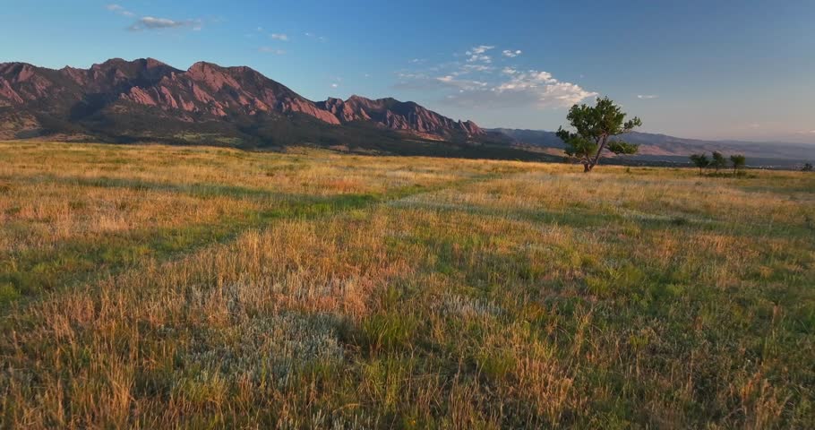 Greenbelt Plateau Flatirons Front Range Boulder Creek neighborhood Chautauqua Park morning sunrise aerial drone Colorado spring summer first light red slanted Rocky Mountains Pikes Peak forward upward