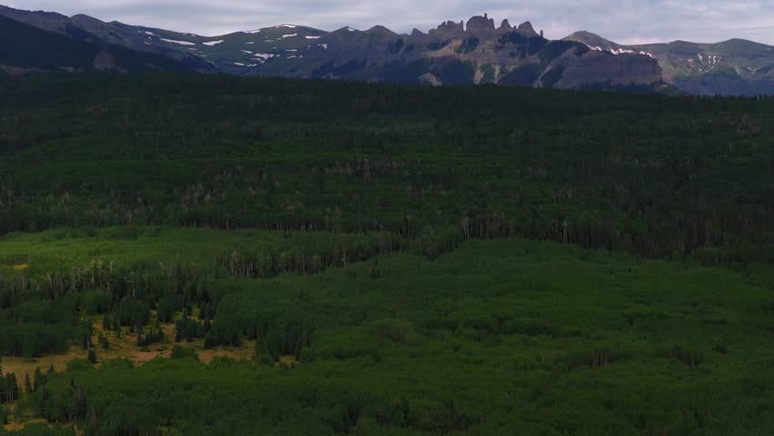Mill Castle rock formation hidden gem Ohio Pass aerial drone Colorado Rocky Mountains spring summer morning cloudy Aspen Tree Forest groves Swampy Kebler Pass Gunnison National Forest forward pan up