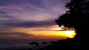 Video 1920x1080 - The rocky shore of tropical ocean at sunset. Timelapse silhouettes 