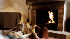 Feet in wool socks near fireplace in winter - Cozy christmas holiday home relaxation - Powered by Shutterstock - Get 15% off with code: PIKWIZARD15
