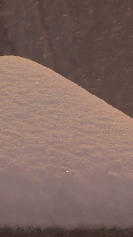 SAPPORO, HOKKAIDO, JAPAN - FEB 2020 : Snow scenery around Susukino city area at night. Soft snow falling at downtown street. Japanese winter and cold snowing season concept vertical video.