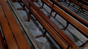 Church interior with empty pews lit by sunbeams through stained glass, scene recorded in calm and silent setting. - Powered by Shutterstock - Get 15% off with code: PIKWIZARD15