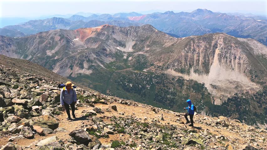 Hiking hikers switchback La Plata Peak 14er summit Sawatch Range 14er spring summer Rocky Mountains Colorado high alpine elevation above treeline Gulch Creek hiking trail morning blue sky pan left