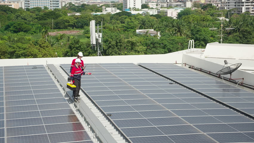 Team engineer and technician working on solar panel installation at rooftop, renewable energy inspection with teamwork, clean power technology for sustainable electricity, industry and solar cell.