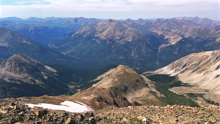 La Plata Peak Gulch Trail 14er view of Independence Pass Sawatch Range 14er spring summer Rocky Mountains Colorado high alpine elevation above treeline hiking trail morning blue sky haze pan left