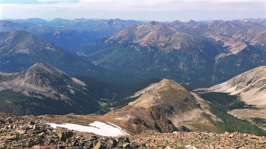 La Plata Peak Gulch Trail 14er view of Independence Pass Sawatch Range 14er spring summer Rocky Mountains Colorado high alpine elevation above treeline snow fields morning blue sky haze static shot