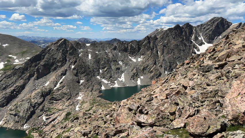Tuhare high alpine twin lakes Halo Ridge Notch Mountain trail view Mount Holy Cross Wilderness Ridge saddle Peak 14er Colorado Sawatch Rocky Mountains sunny morning landscape blue sky clouds pan left