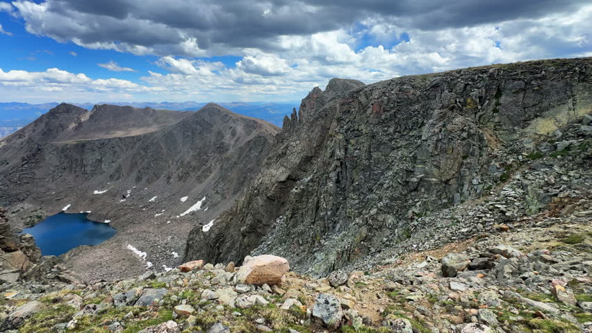 Tear of Bowls high alpine lake Halo Ridge Notch Mountain trail view Mount Holy Cross Wilderness Ridge saddle Peak 14er Colorado Sawatch Rocky Mountains sunny morning landscape blue sky clouds pan left