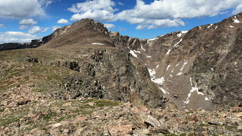 Halo Ridge trail Notch Mountain Mount Holy Cross Wilderness catwalk Ridge saddle summit Peak 14er Colorado Sawatch Rocky Mountains sunny morning landscape blue sky clouds snow fields pan right motion