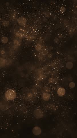 Luxury background with glittering shiny gold particles and shimmering bokeh light spheres. Elegant golden vertical background ideal for glamorous events, award ceremonies or talent shows. 