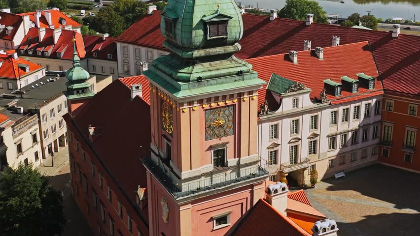 Cinematic orbit of Royal Castle Warsaw showing clock tower, rooftops and river