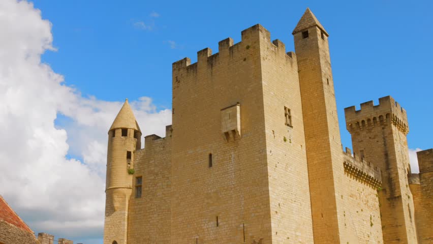 Breathtaking Château de Beynac, a stunning medieval castle set against the scenic backdrop of one of France’s most beautiful villages. The vibrant sky enhances its unique architecture.