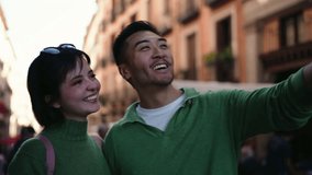 Smiling young couple taking selfie or video call outdoors, enjoying digital connection. Concept of love, happiness, social media lifestyle, and modern communication - Powered by Shutterstock - Get 15% off with code: PIKWIZARD15