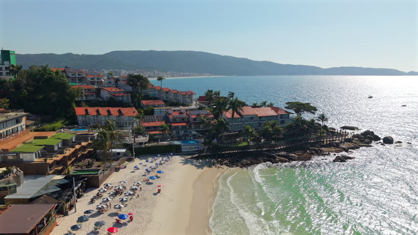 Aerial panorama of Bombas tropical beach with shoreline beach goers at turquoise Atlantic Ocean, Bombinhas, Santa Catarina, Brazil.