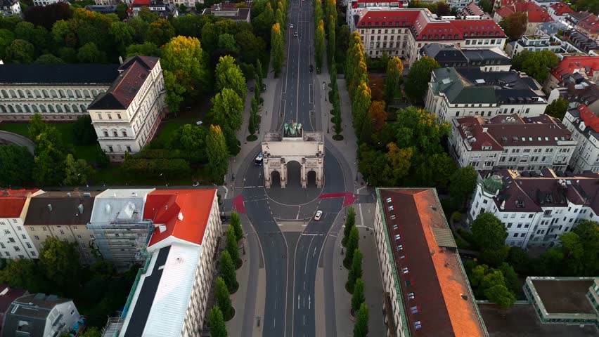Aerial view of Siegestor on Ludwigstrasse, Munich, Germany, sunrise, summer cityscape, Bavaria statue with lions, historic triumphal arch, classical architecture, Munich skyline, urban panorama. 