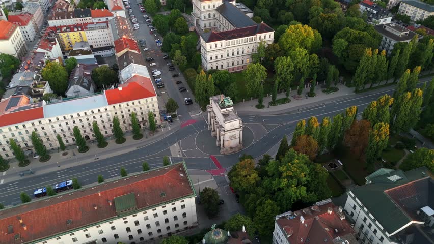 Stunning top view of Siegestor on Ludwigstrasse, Munich, Germany, Bavaria figure, and surrounding streets, highlighting historic classical architecture, summer morning light, ideal for aerial and