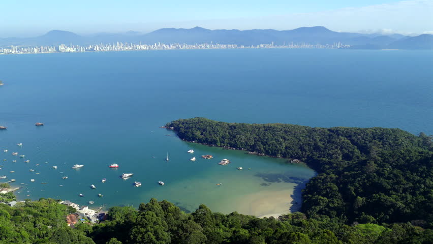Brazilian paradise Caixa D’aço Beach with boats and vibrant shoreline scenery, Itapanema, Santa Catarina