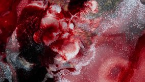 Expanding wave of thick red ink with glitter. Macro view - Powered by Shutterstock - Get 15% off with code: PIKWIZARD15