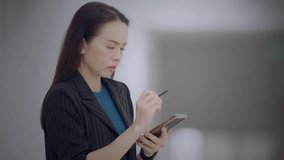Asian businesswoman using stylus to interact with futuristic virtual dashboard showing colorful bar charts. Concept of big data, analytics, business intelligence. - Powered by Shutterstock - Get 15% off with code: PIKWIZARD15