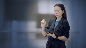Asian businesswoman using stylus and tablet to interact with virtual dashboard showing global data, charts, and analytics. Concept of digital business and big data. - Powered by Shutterstock - Get 15% off with code: PIKWIZARD15