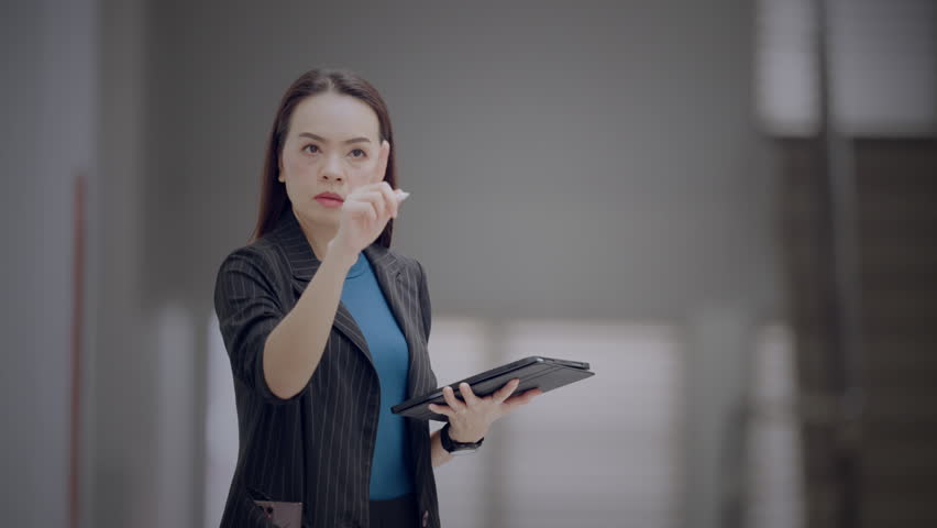 Asian businesswoman interacting with futuristic dashboard showing progress bars and financial metrics. Concept of business performance, KPI, and data analysis. - Powered by Shutterstock - Get 15% off with code: PIKWIZARD15